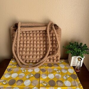 Vintage style tan crocheted pompom purse with wooden dowels and woven straps